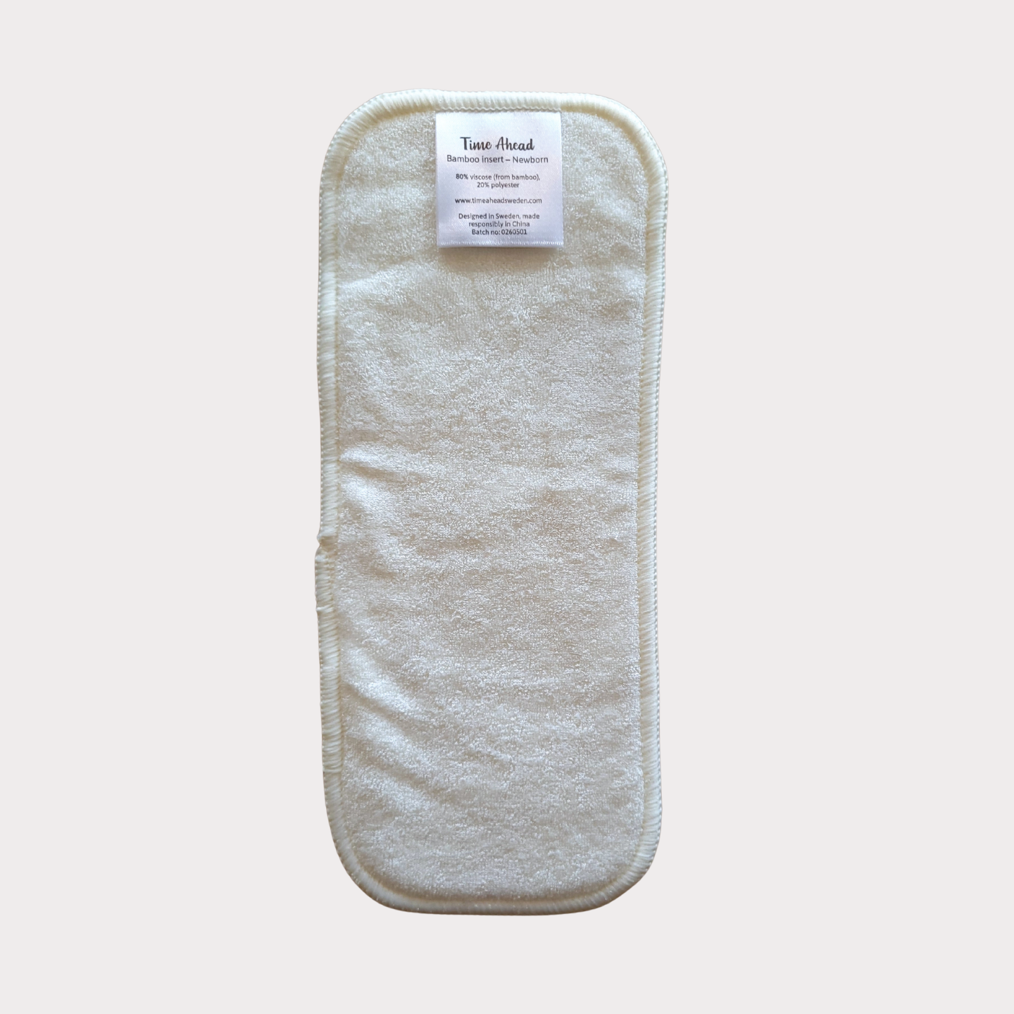 The loose bamboo terry booster included with the newborn nappy.