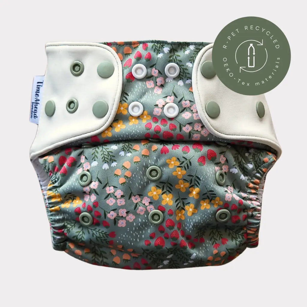 Tygblöja Komfort 5–17 kg i mönstret Dalablomster, sedd framifrån.