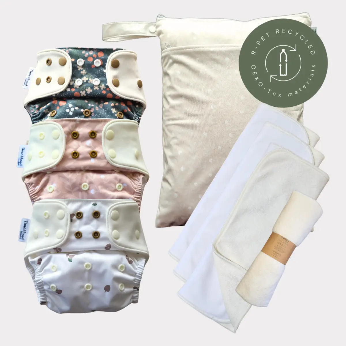 Miljövänligt återanvändbart tygblöjs-set med pastellfärgade blommönster och prickmönster, tillverkat av ekologisk bomull.