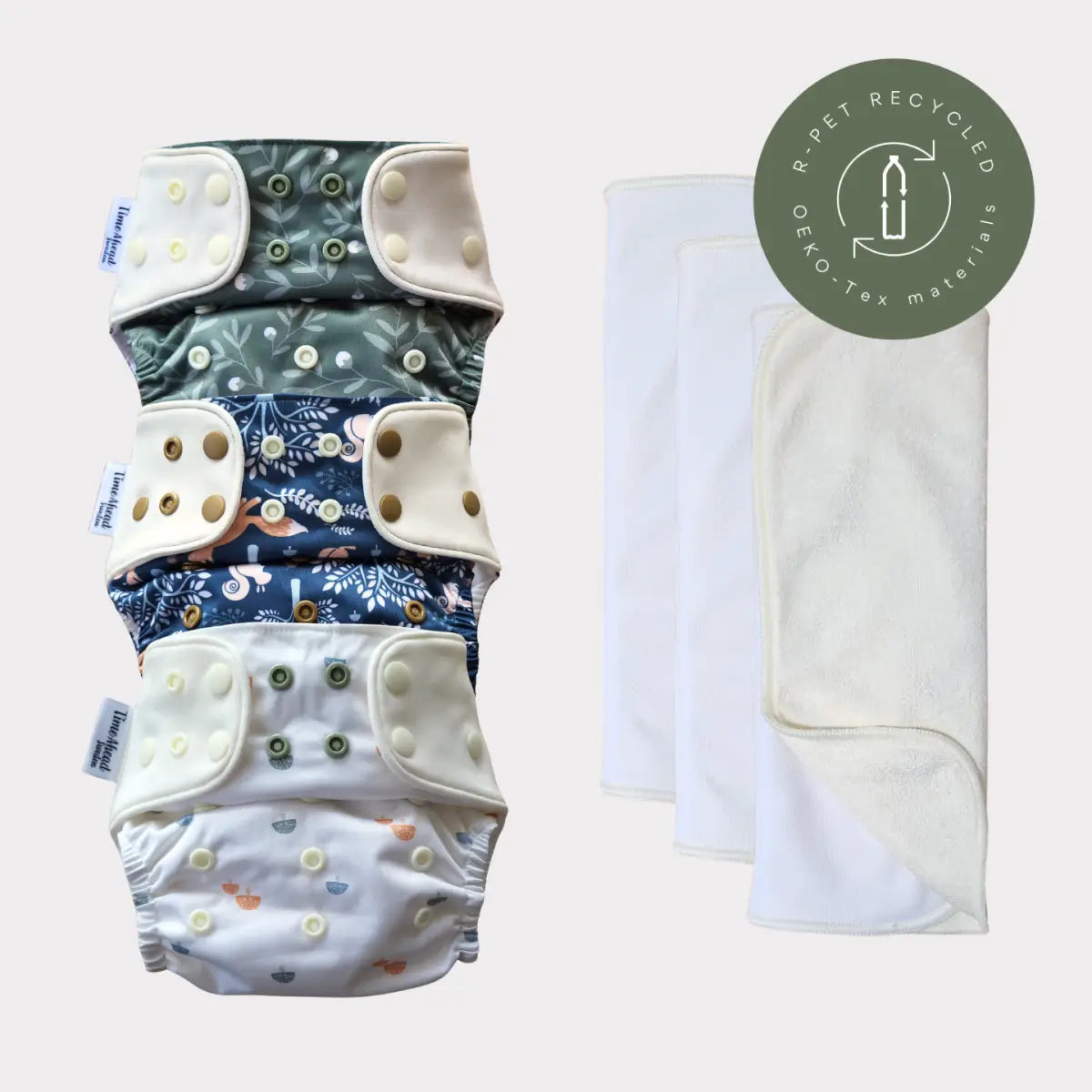 Stacked eco-friendly allt-i-ett blöja with soft fabric and snap closures in muted greens and blues for barnets hud and a medvetet val