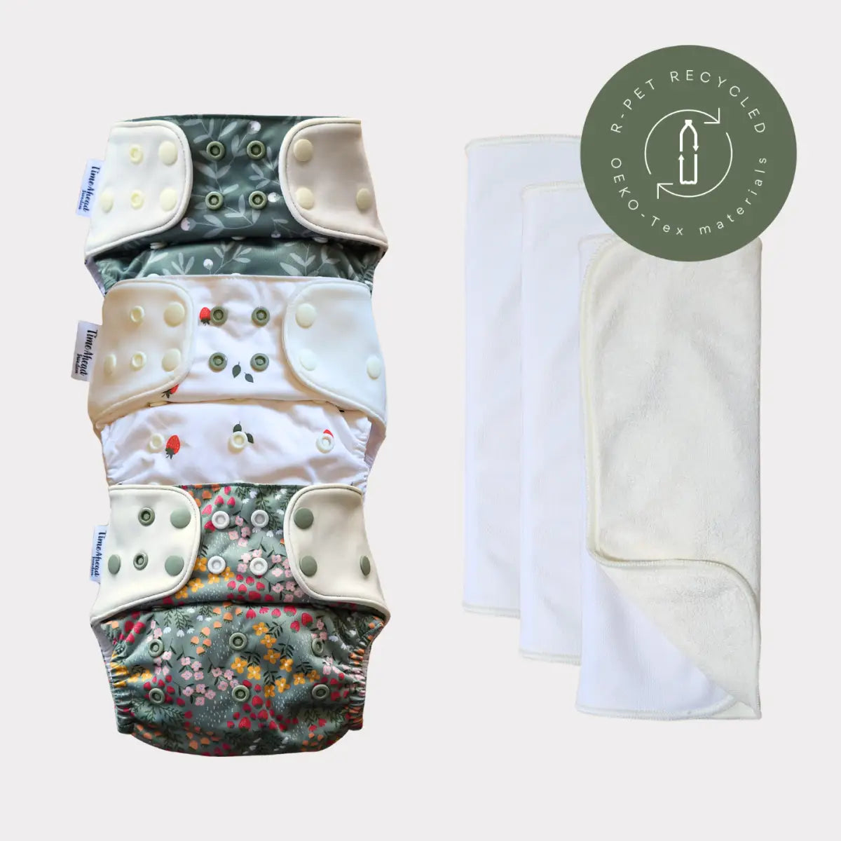 Staplad tygblöjor med blommönster och tryckknäppningar, tillverkade av r-pet återvunna oeko-tex-material.